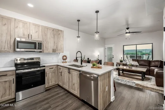 a kitchen with a stove a sink and a microwave