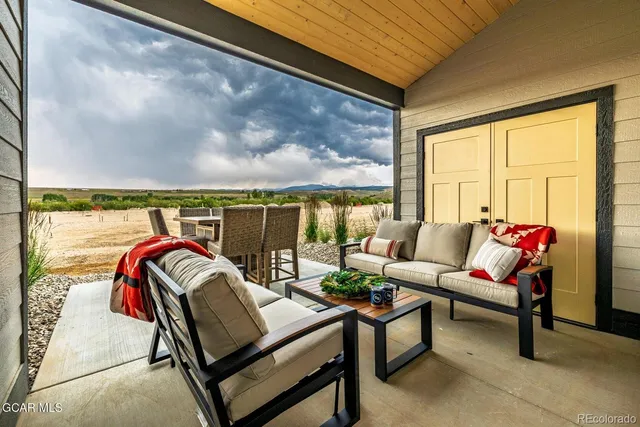 a outdoor living space with furniture and a flat screen tv