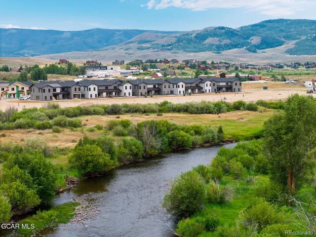 a view of a city with lots of residential buildings and mountain view