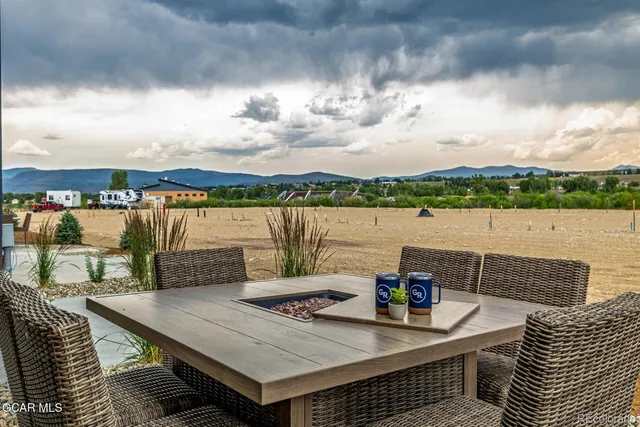 a view of roof deck with lake and mountain view
