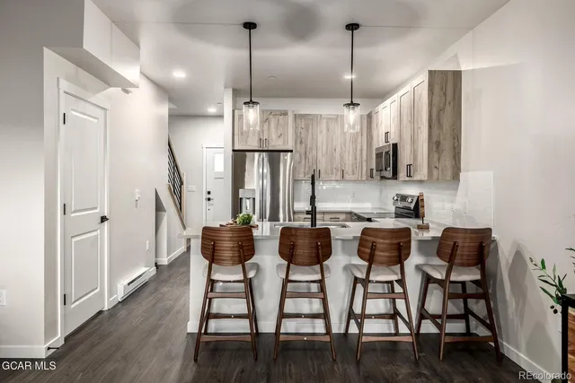 a view of kitchen with furniture and wooden floor