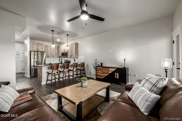 a living room with furniture and kitchen view