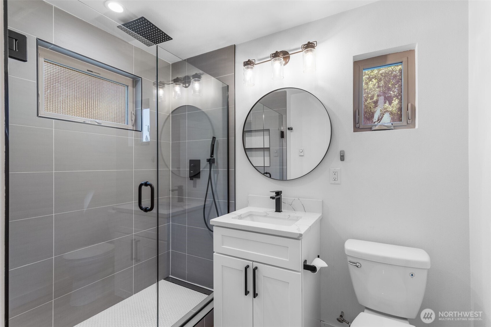 2125 North 90th Street Seattle, WA 98103 - Photo 11 of 29 a bathroom with a toilet a sink and mirror