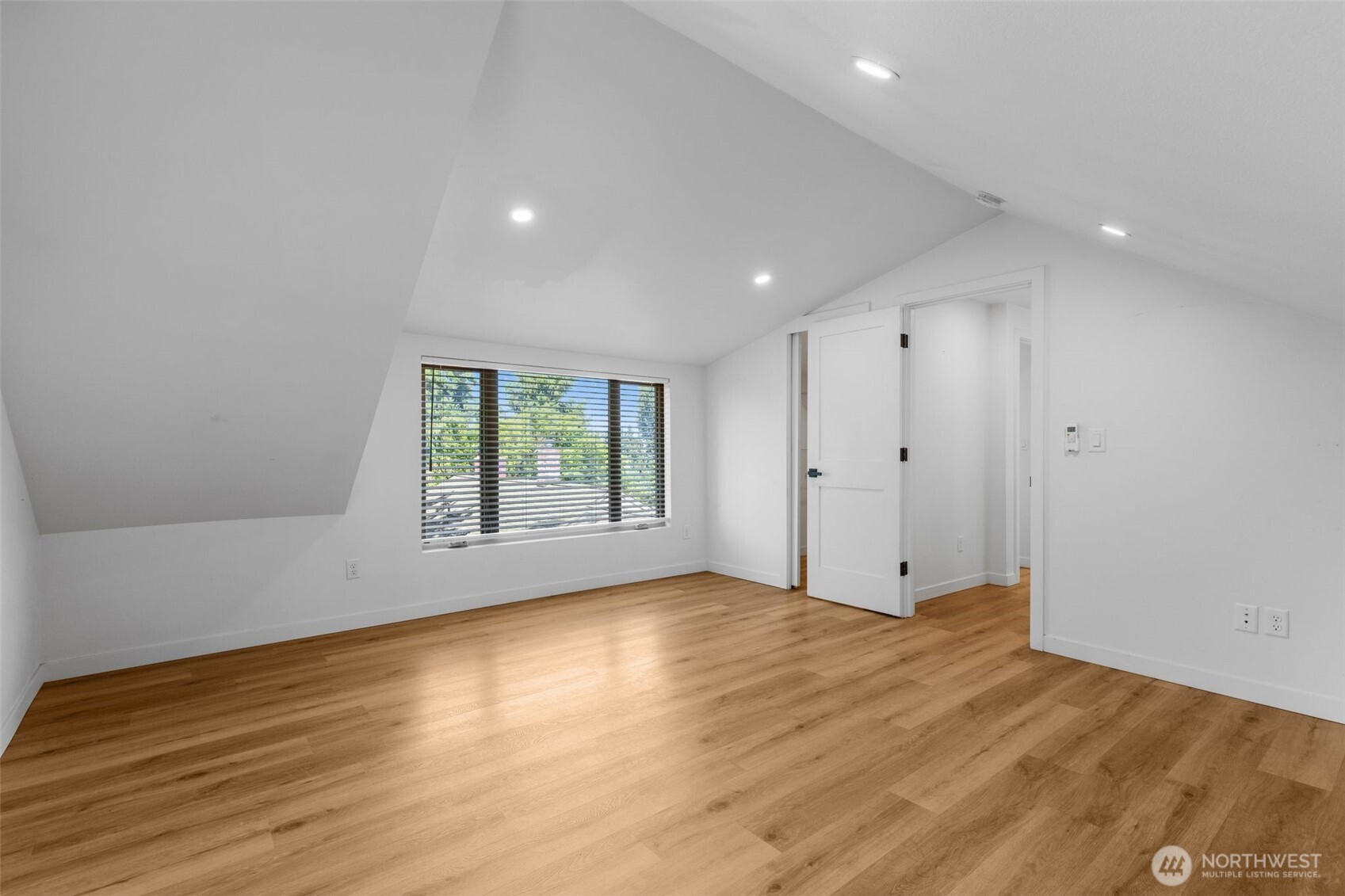 2125 North 90th Street Seattle, WA 98103 - Photo 15 of 29 a view of an empty room with wooden floor and a window