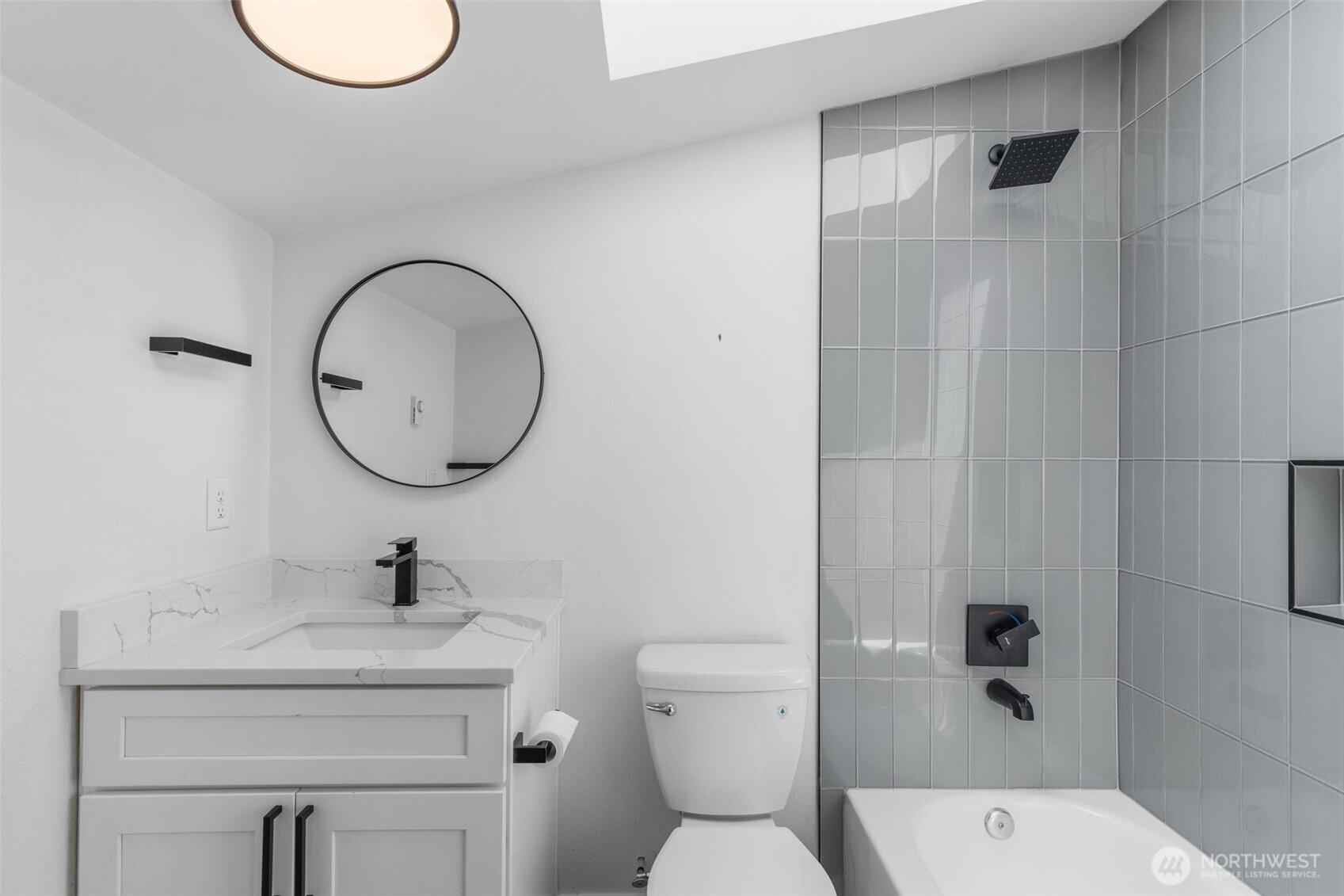 2125 North 90th Street Seattle, WA 98103 - Photo 17 of 29 a bathroom with a toilet a sink and a mirror