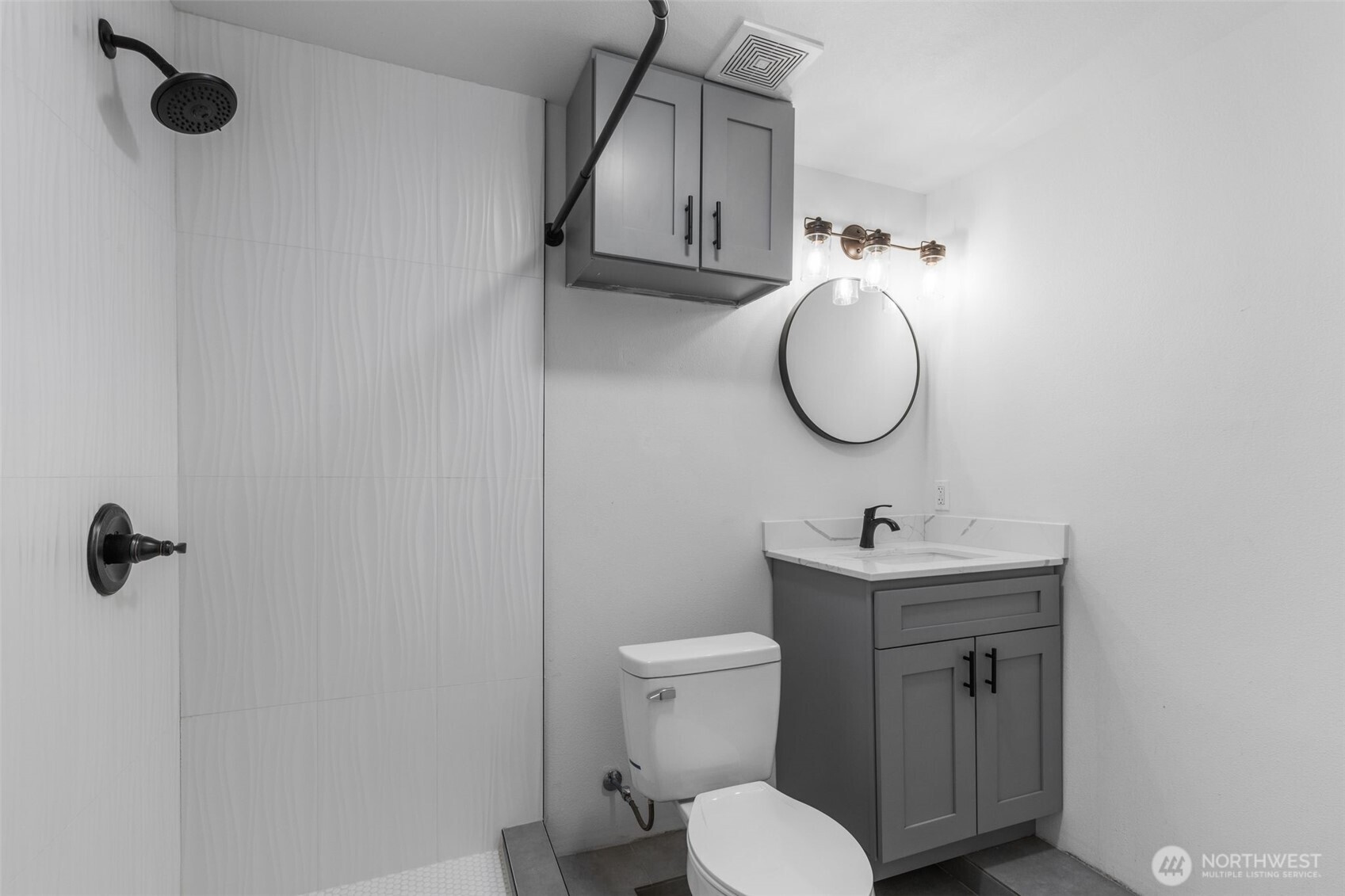 2125 North 90th Street Seattle, WA 98103 - Photo 21 of 29 a bathroom with a toilet sink and mirror