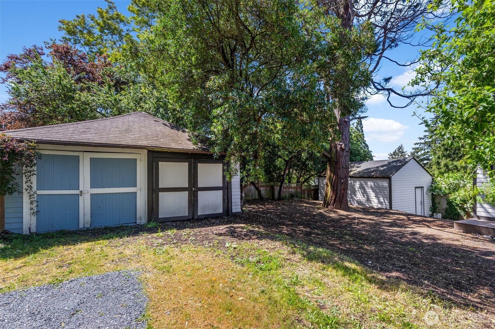 2125 North 90th Street Seattle, WA 98103 - Photo 25 of 29 a house with a large tree in front of it
