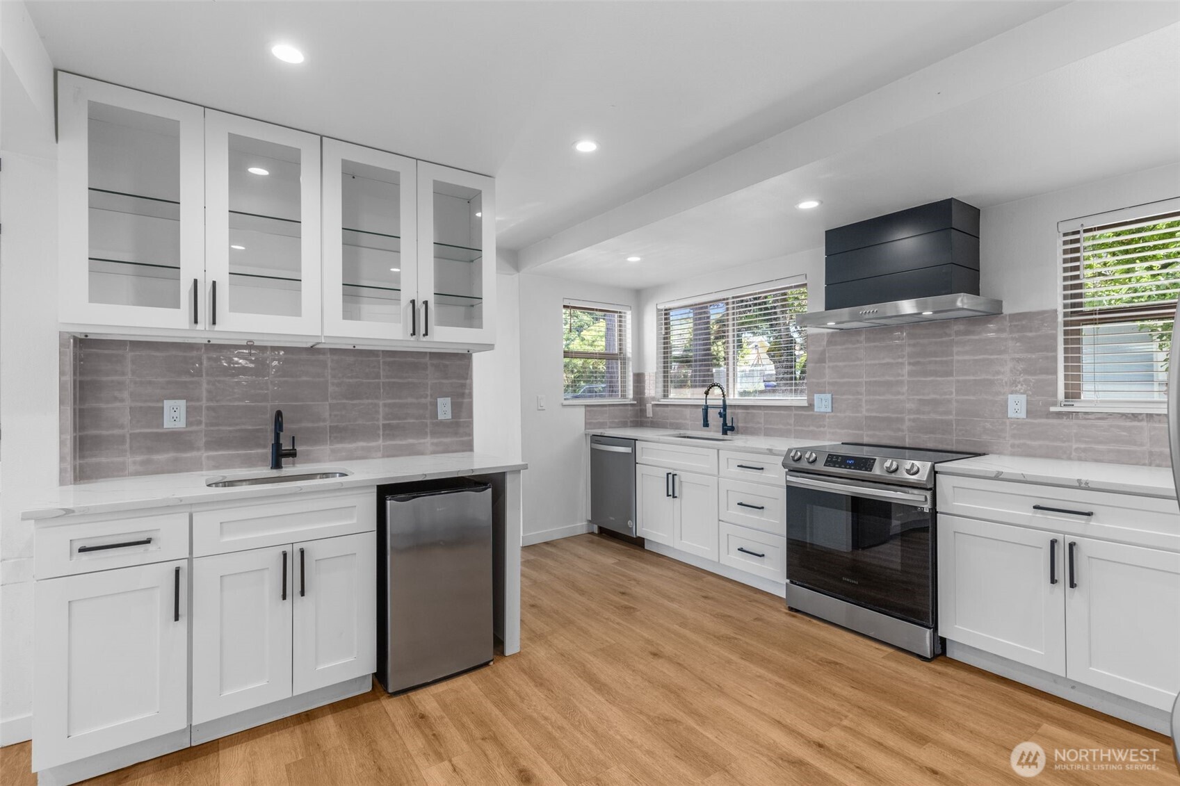 2125 North 90th Street Seattle, WA 98103 - Photo 8 of 29 a kitchen with a sink stove and cabinets