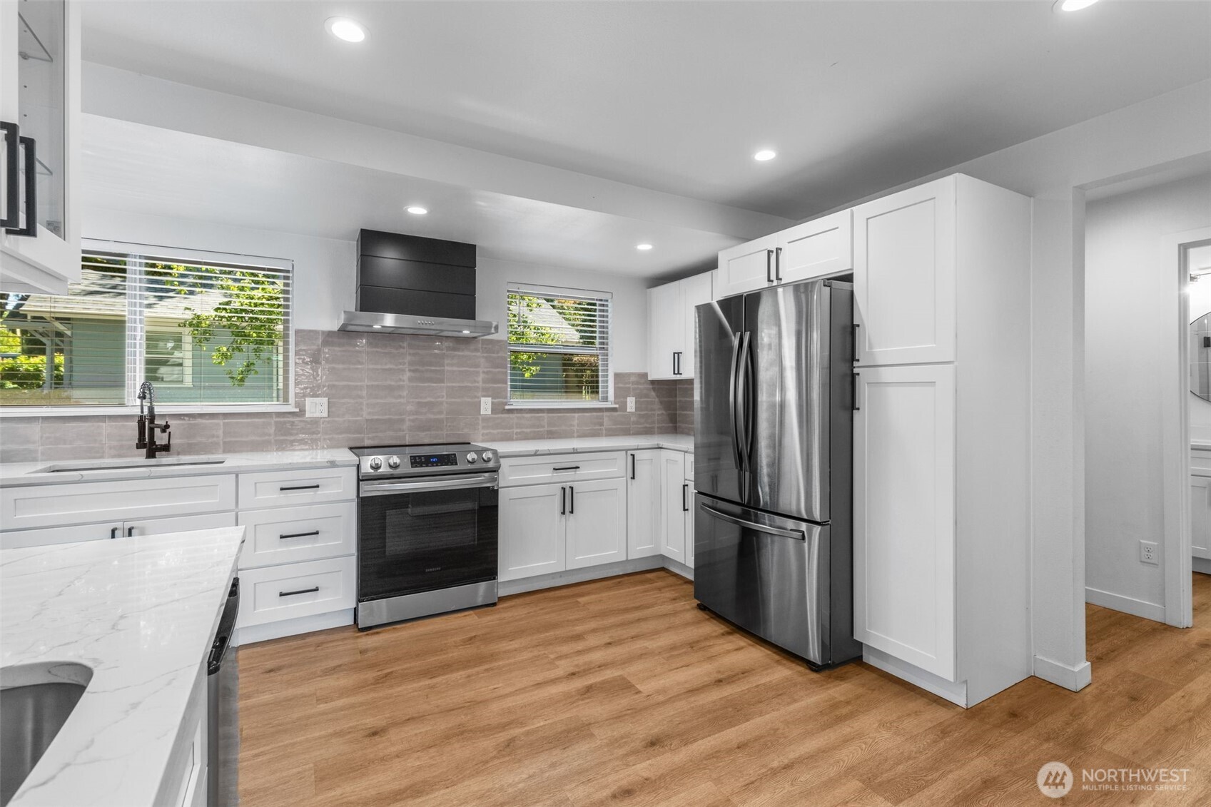 2125 North 90th Street Seattle, WA 98103 - Photo 9 of 29 a kitchen with stainless steel appliances granite countertop a refrigerator sink and stove