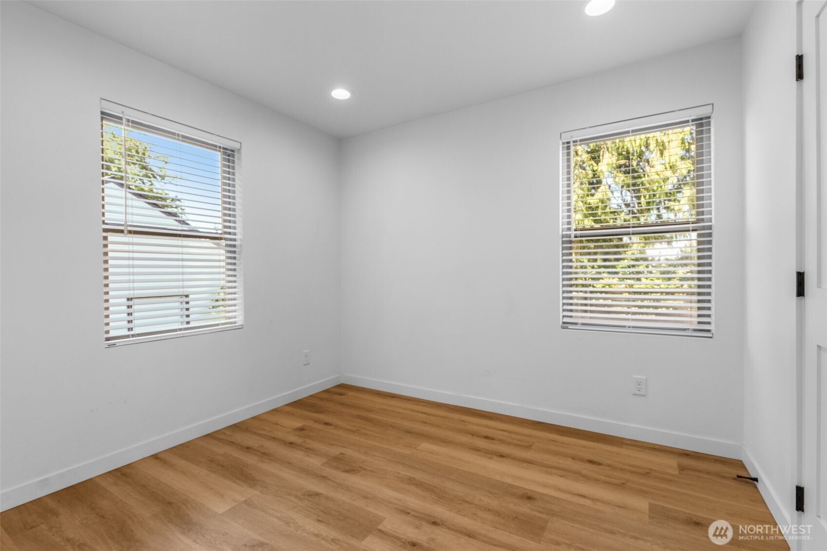 2125 North 90th Street Seattle, WA 98103 - Photo 10 of 29 a view of empty room with wooden floor and fan