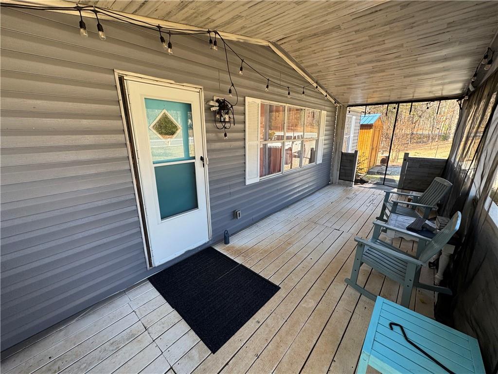 524 Pink Williams Road Dahlonega, GA 30533 - Photo 28 of 39 a view of a deck with wooden floor and furniture