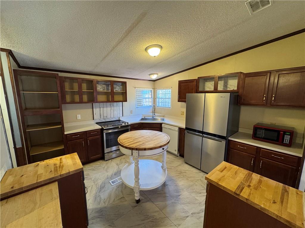 524 Pink Williams Road Dahlonega, GA 30533 - Photo 4 of 39 a kitchen with stainless steel appliances wooden floor and chairs