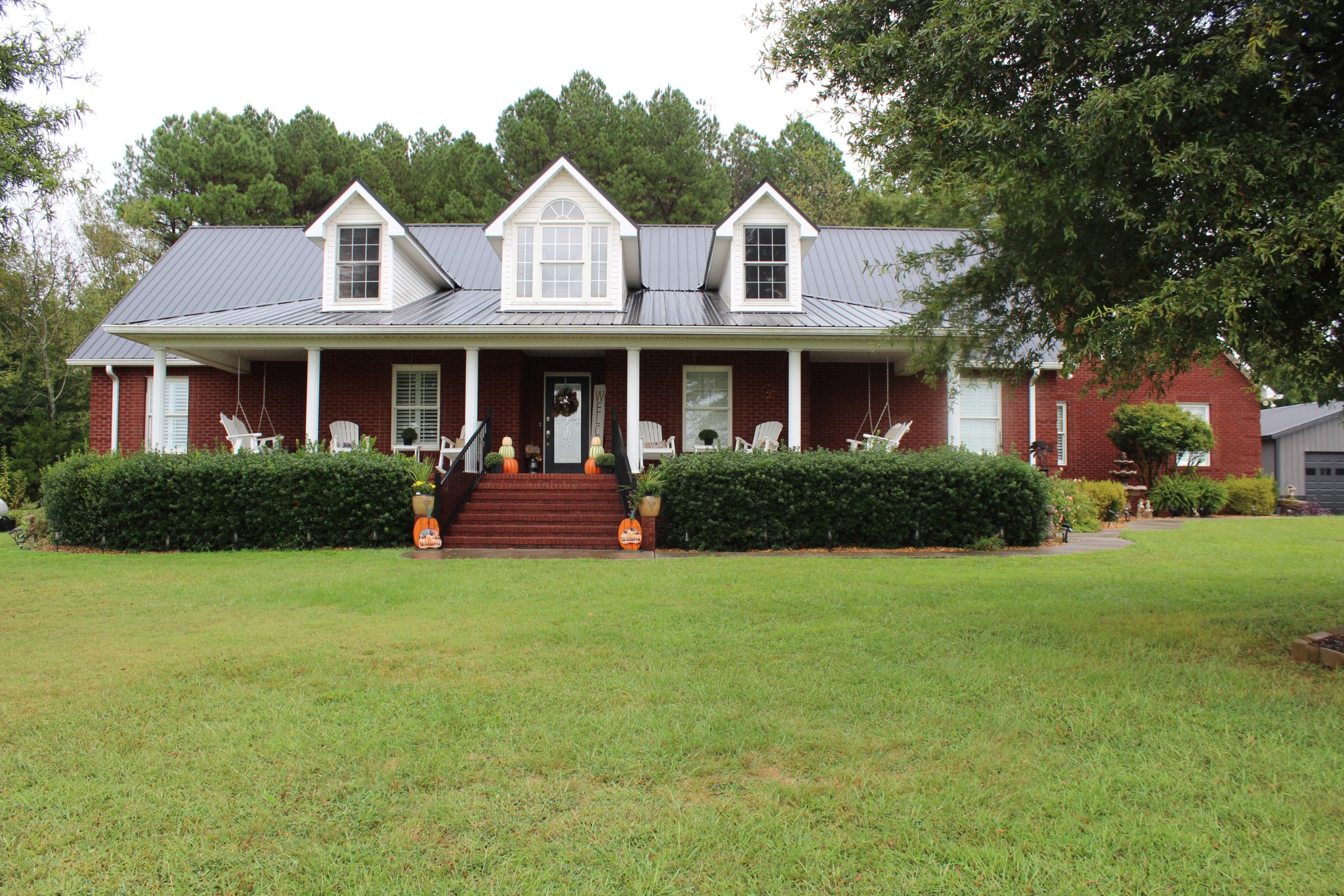 a front view of a house with garden