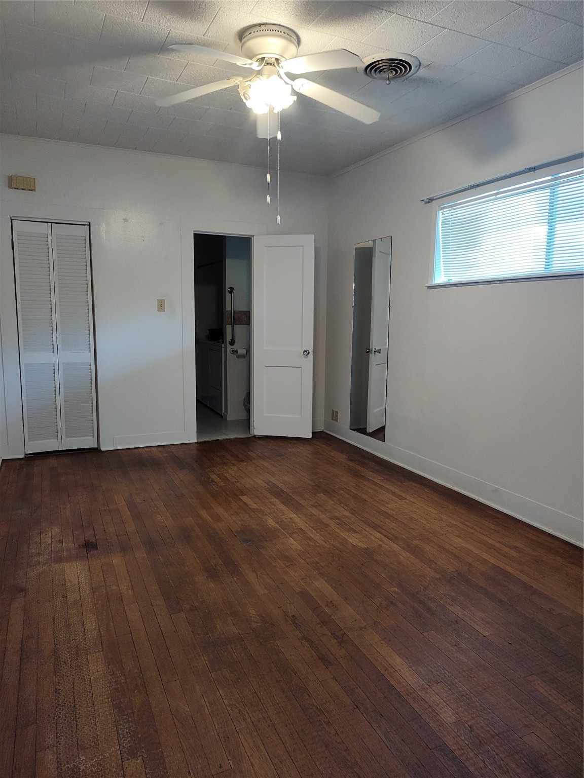 2417 Cos Street Liberty, TX 77575 - Photo 8 of 9 an empty room with wooden floor closet and windows