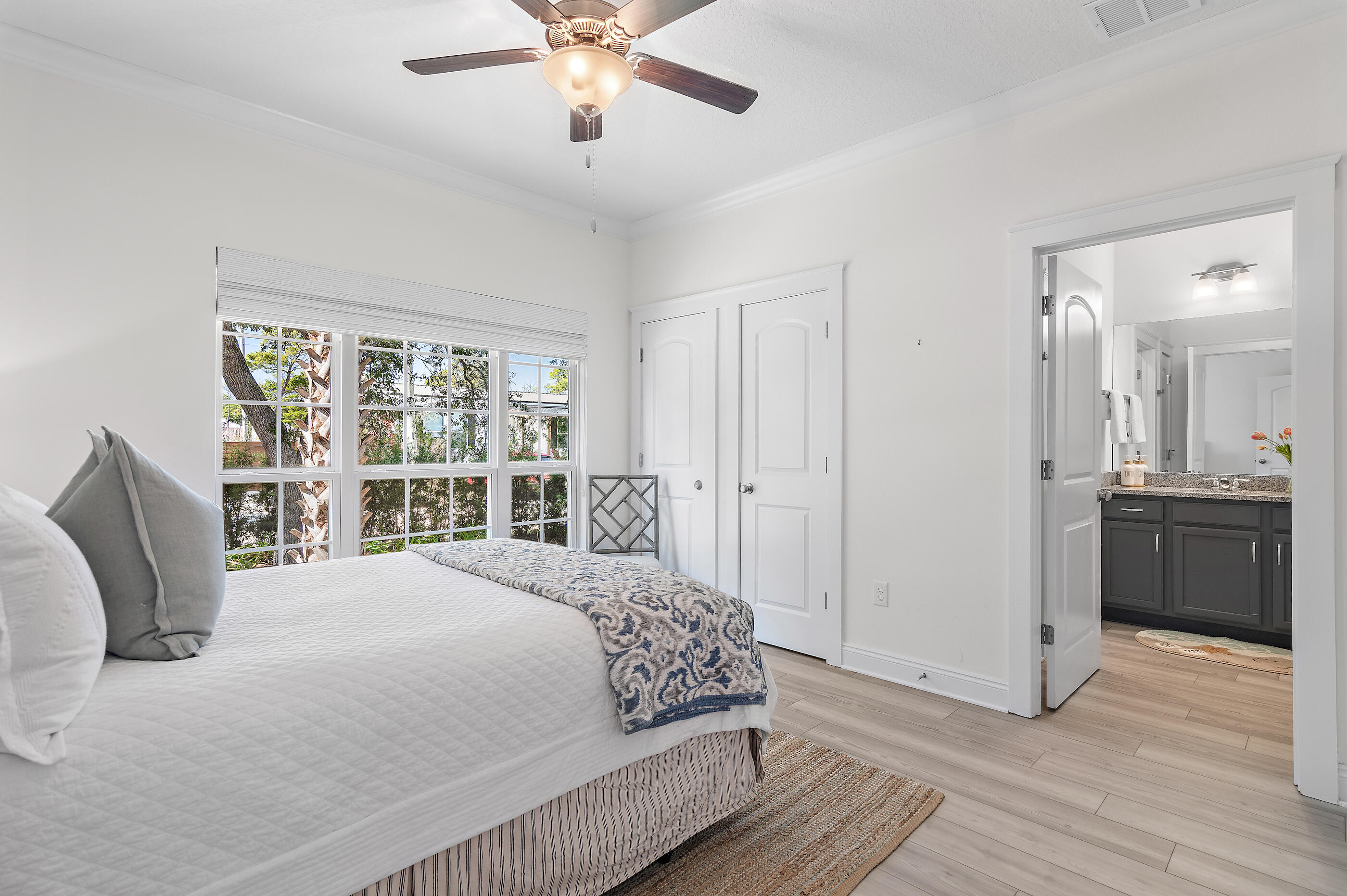 288 Robert Ellis Street Santa Rosa Beach, FL 32459 - Photo 33 of 61 a spacious bedroom with a large bed and a chandelier
