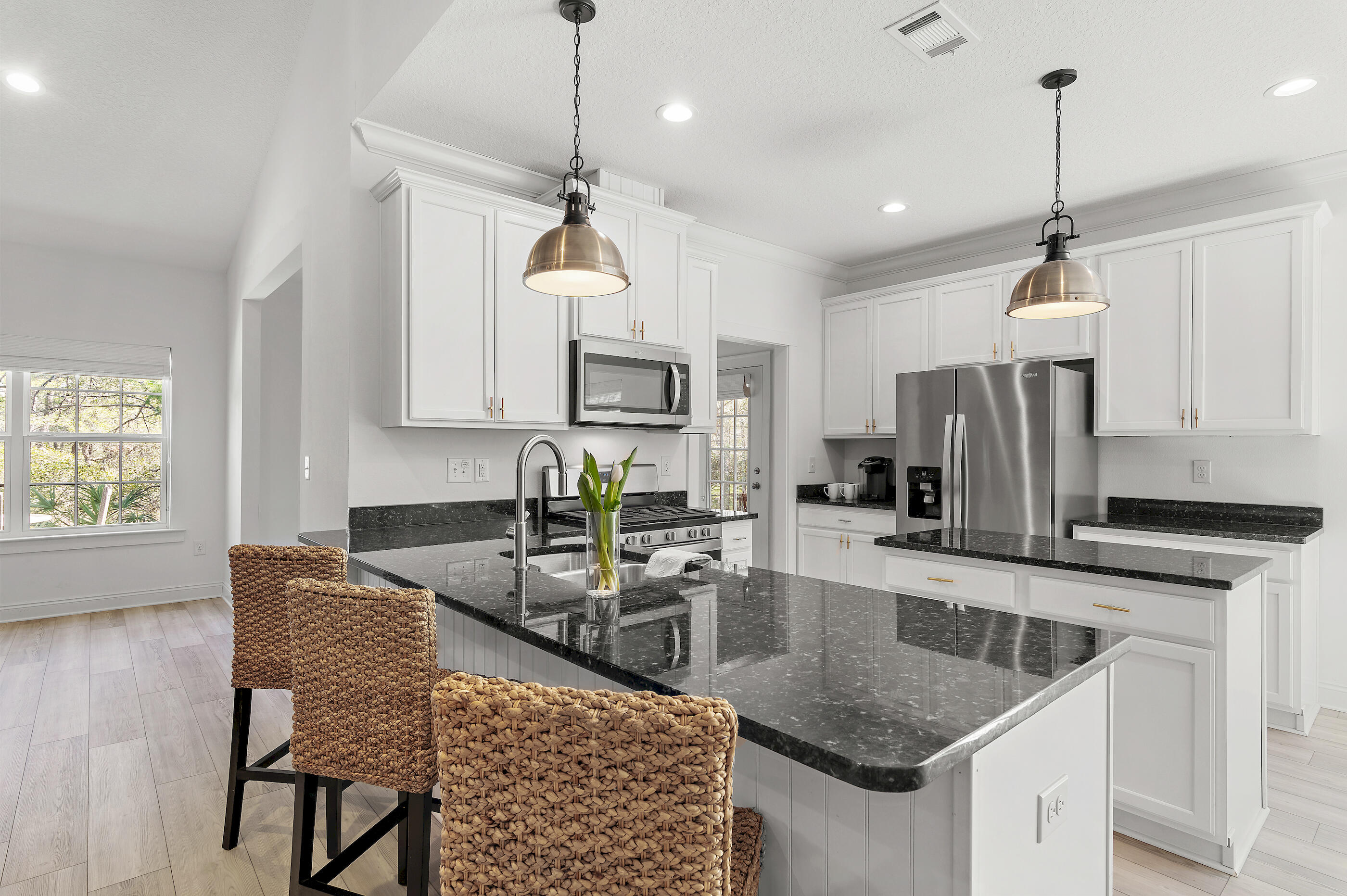 288 Robert Ellis Street Santa Rosa Beach, FL 32459 - Photo 7 of 61 a kitchen with stainless steel appliances granite countertop a sink a stove a refrigerator cabinets and chairs