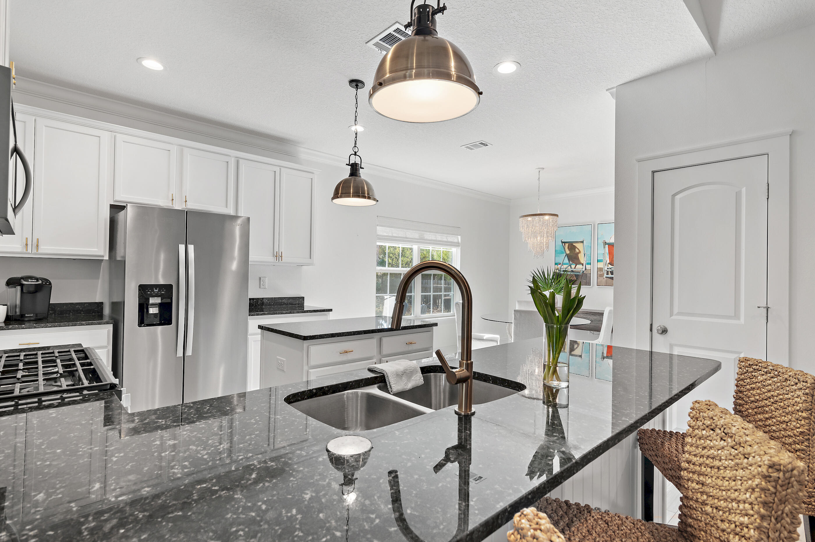 288 Robert Ellis Street Santa Rosa Beach, FL 32459 - Photo 8 of 61 a kitchen with granite countertop a table chairs stove and refrigerator