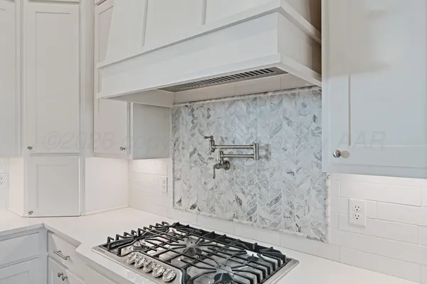 a utility room with stainless steel appliances lots of clutter