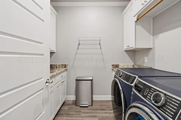 a kitchen with white cabinets and a sink