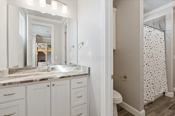 a bathroom with a shower curtain and a sink