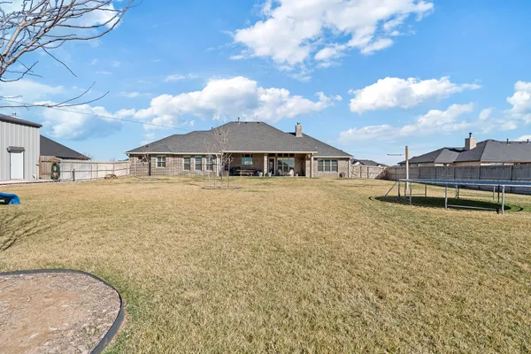 a view of a house with swimming pool and sitting area