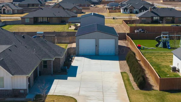 an aerial view of a house with a yard