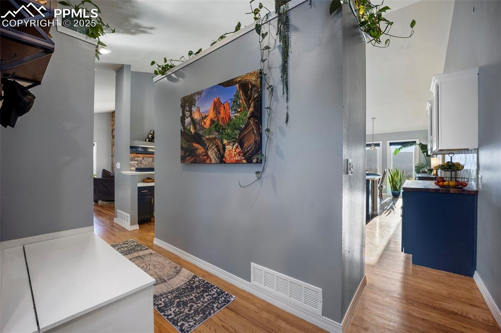 17810 New London Road Monument, CO 80132 - Photo 12 of 50 a view of a hallway view with wooden floor and staircase