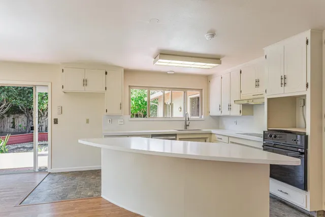 a kitchen with stainless steel appliances granite countertop a sink and a stove