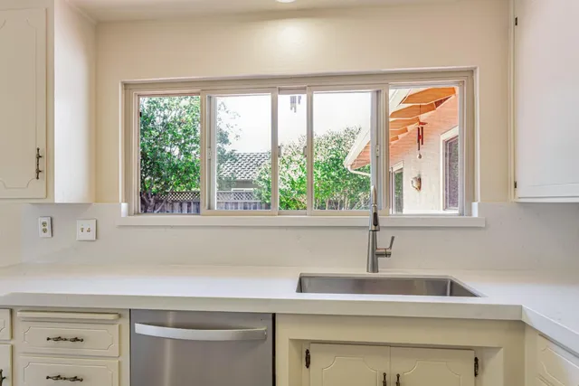 a kitchen with a sink and a window