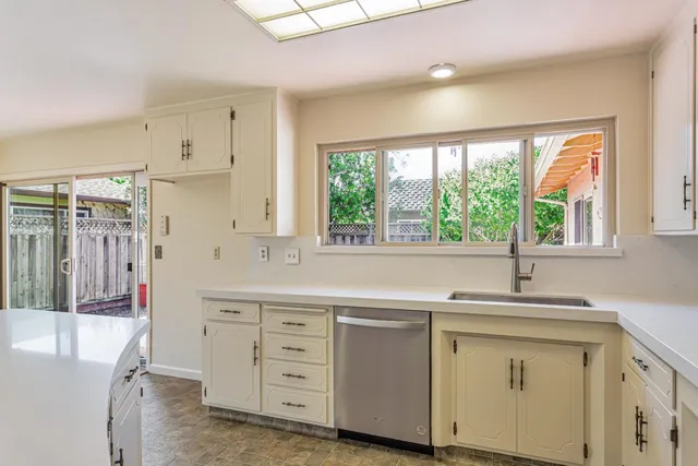 a kitchen with a sink stove and cabinets