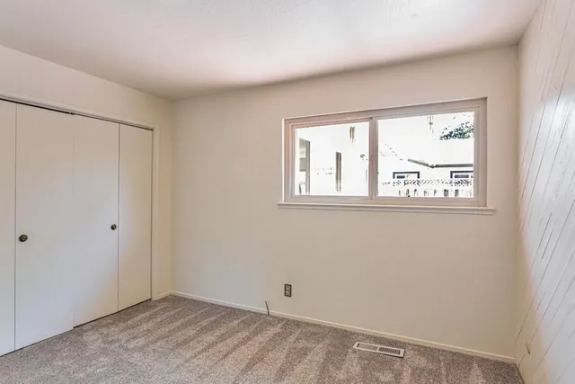 a bathroom with a granite countertop sink a mirror and a shower