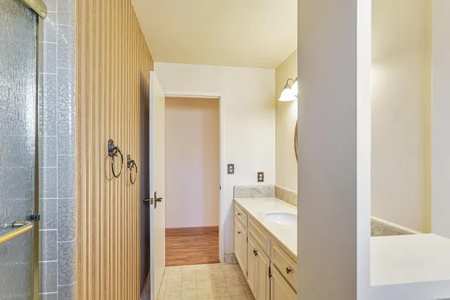 a view of a room with wooden floor and a ceiling fan