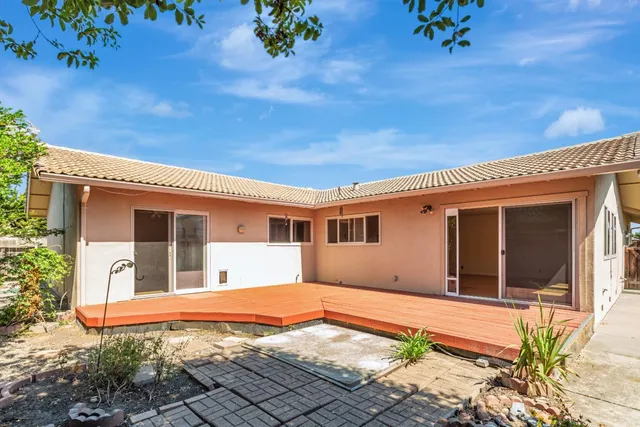 a backyard of a house with a table and chairs