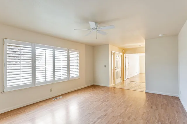 wooden floor in an empty room with a window