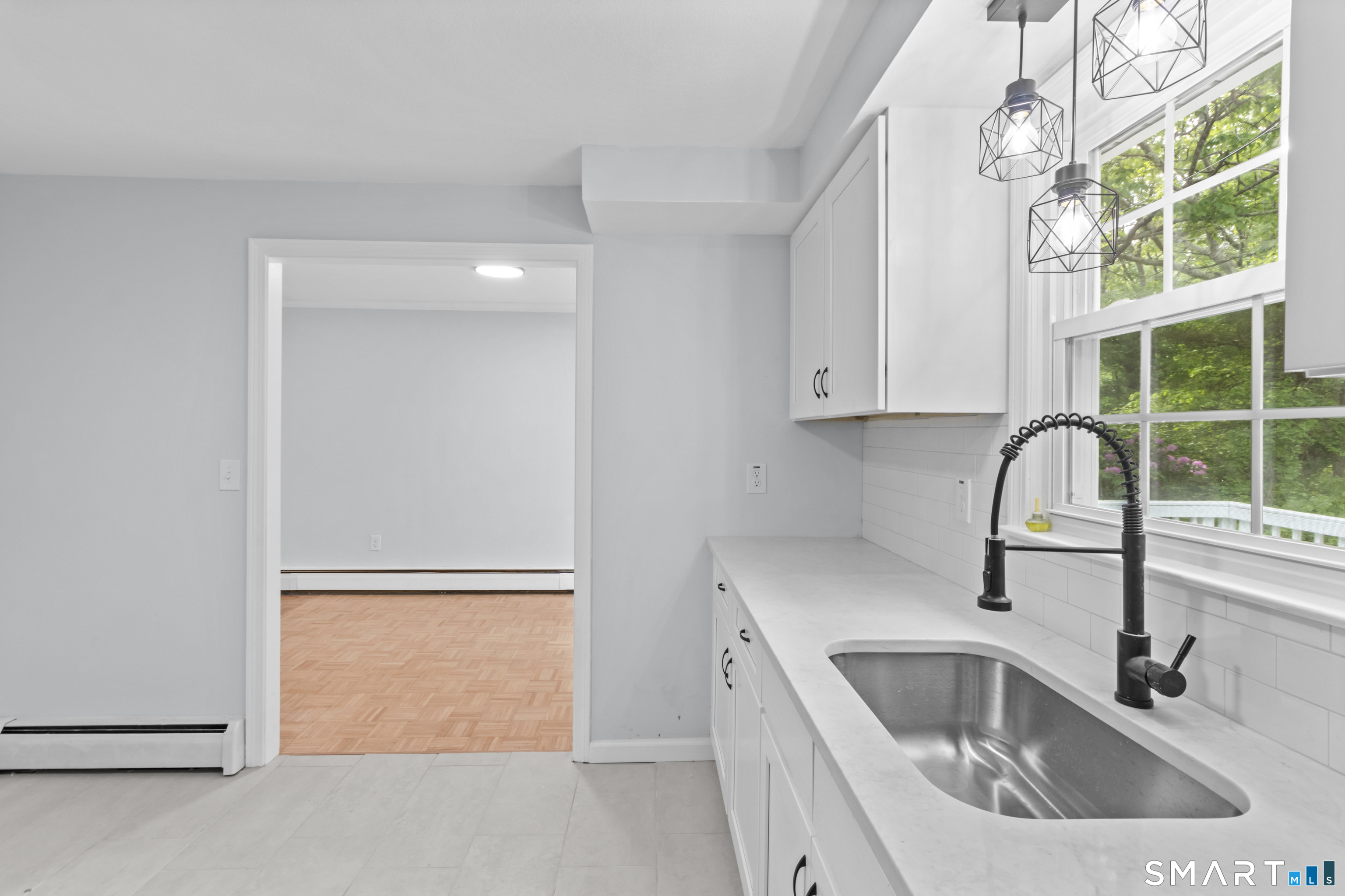 20 Quiet Woods Road East Hampton, CT 06424 - Photo 3 of 40 a kitchen with a sink a window and stainless steel appliances