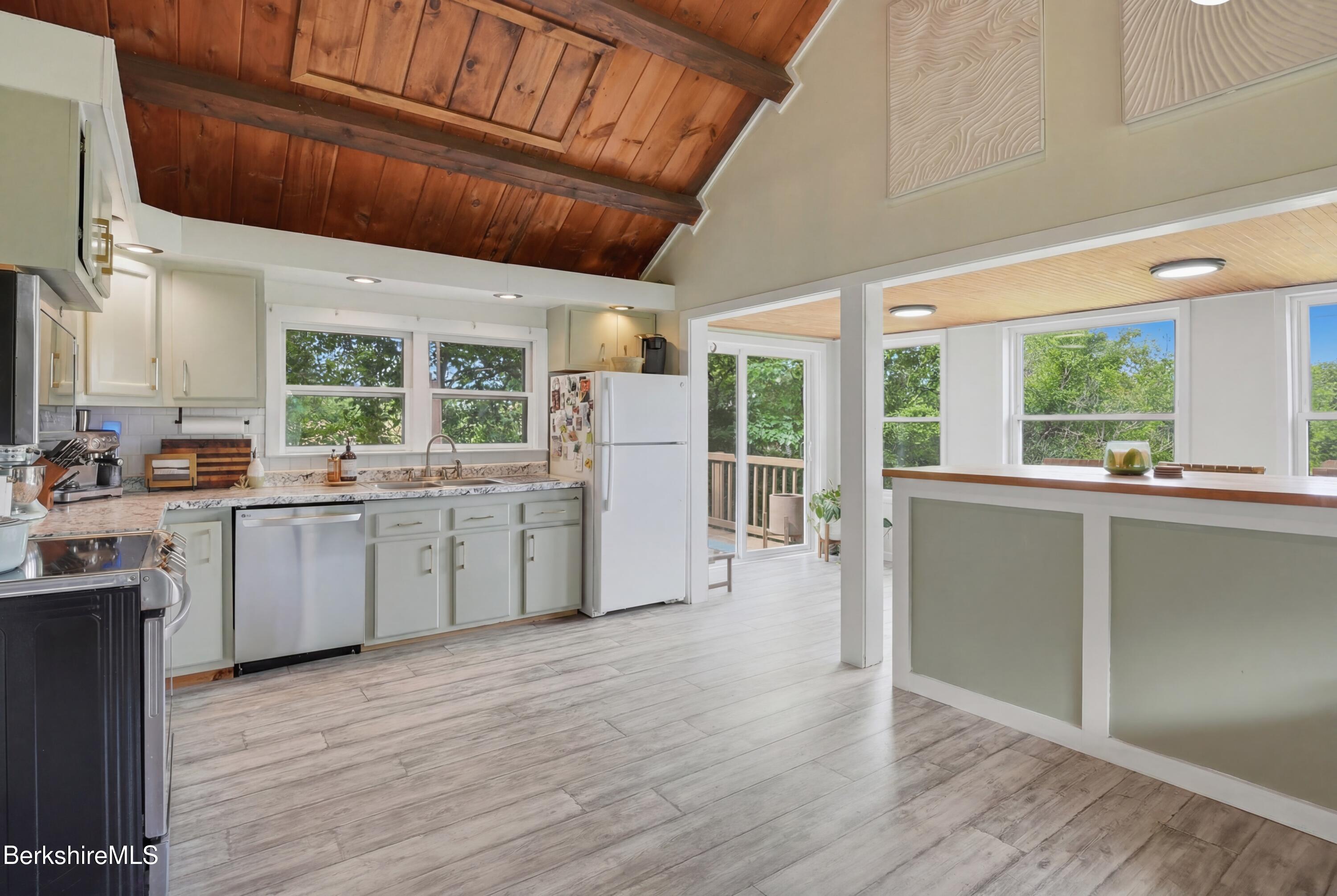 4 David Drive Peru, MA 01235 - Photo 10 of 44 a kitchen with a wooden floor and white stainless steel appliances
