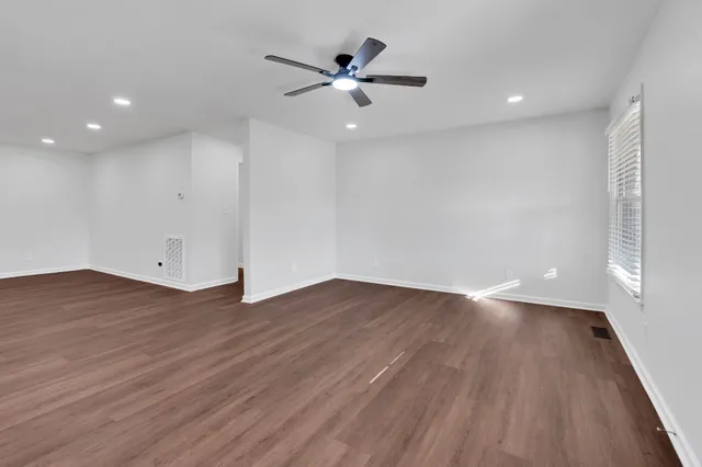 a view of a kitchen with a sink and wooden floor