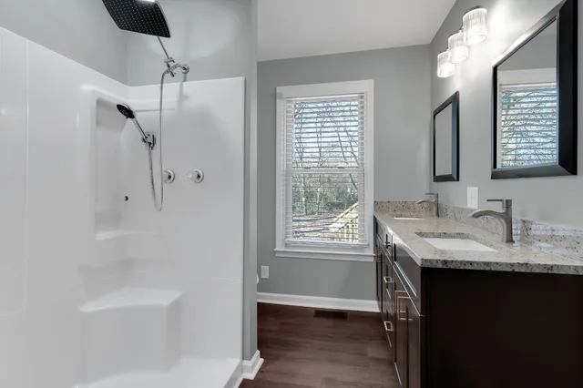 a view of a room with wooden floor and windows