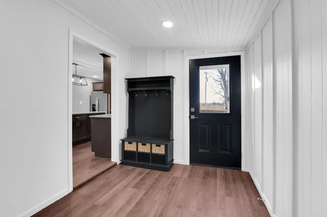 a view of a hallway with wooden floor