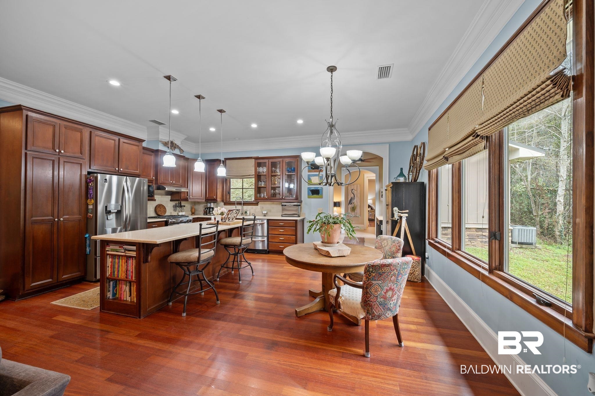 7850 Yorkhaven Road Mobile, AL 36695 - Photo 13 of 57 Dining space with visible vents, arched walkways, crown molding, a healthy amount of sunlight, and dark wood-style flooring