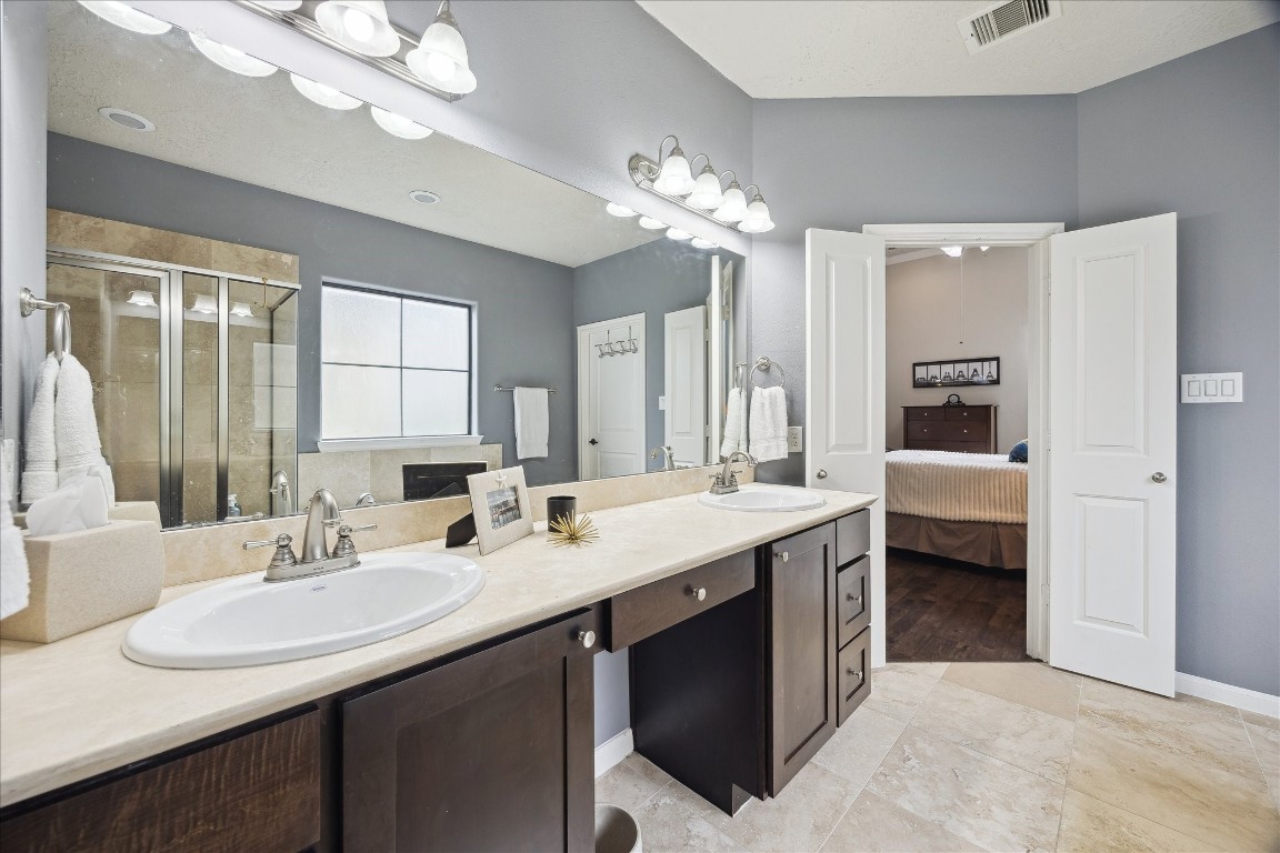 1110 West 25th Street Houston, TX 77008 - Photo 23 of 40 a en suite bathroom with a double vanity sink a mirror and a shower