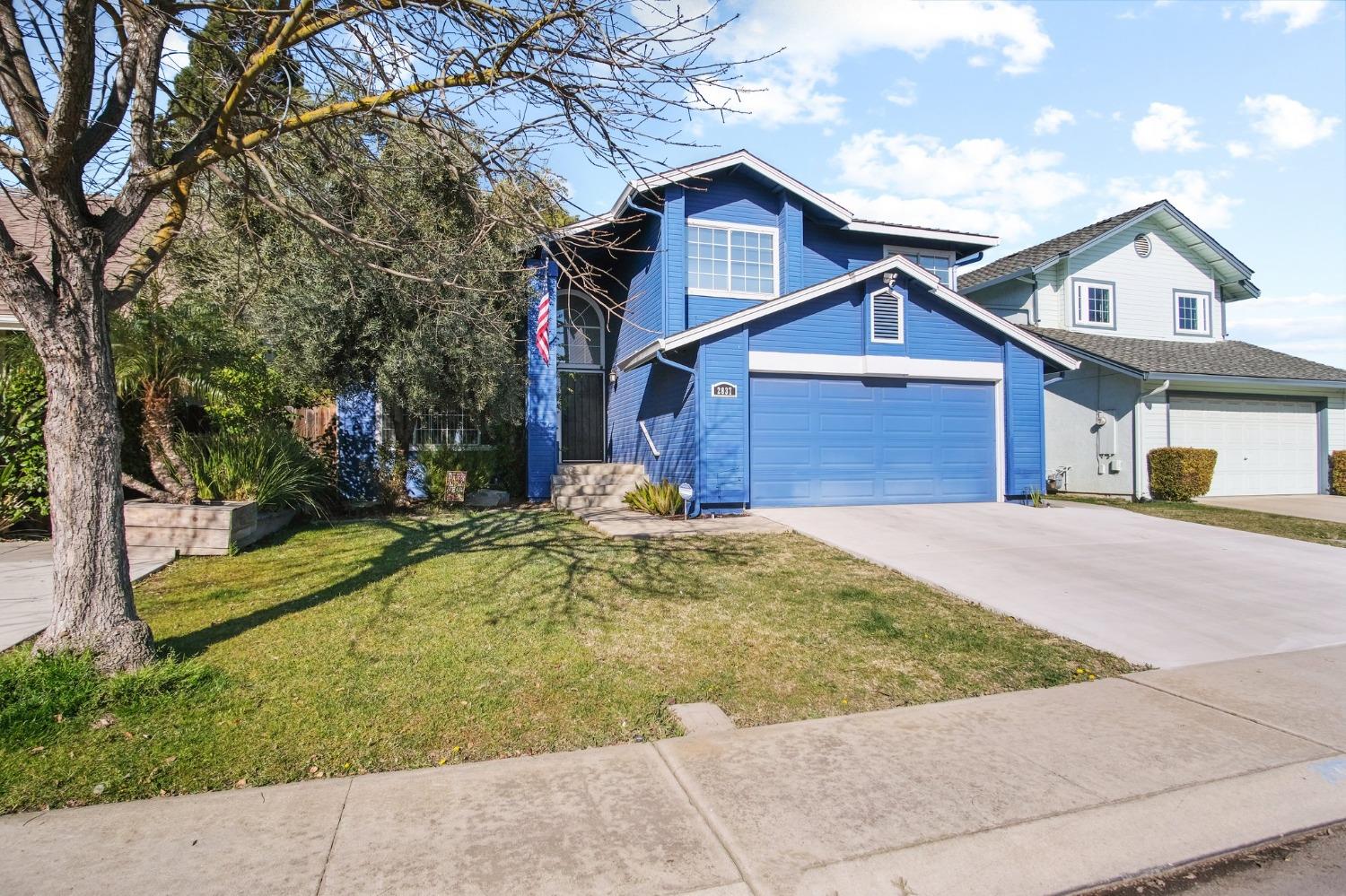 2837 Walnut Terrace Modesto, CA 95355 - Photo 1 of 1 a view of a house with a yard and large tree
