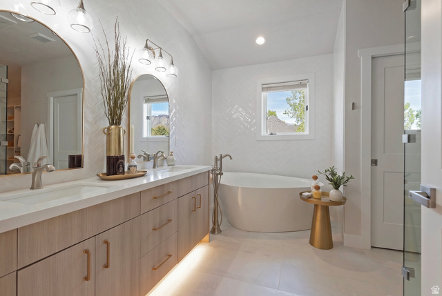 16 Gatehouse Lane Sandy, UT 84092 - Photo 26 of 73 Full bath featuring double vanity, a soaking tub, healthy amount of natural light, and recessed lighting