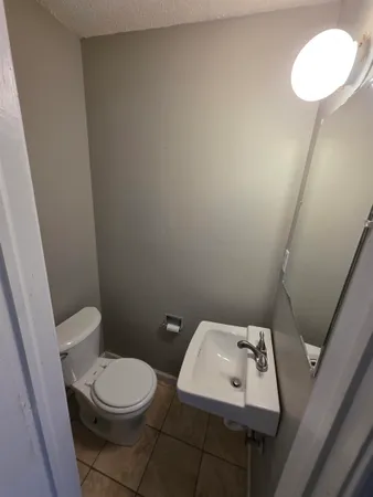 a white toilet sitting next to a bathroom sink