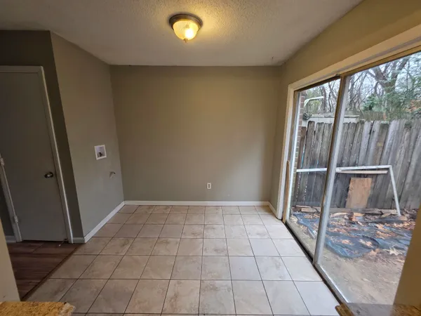 an empty room with wooden floor and door