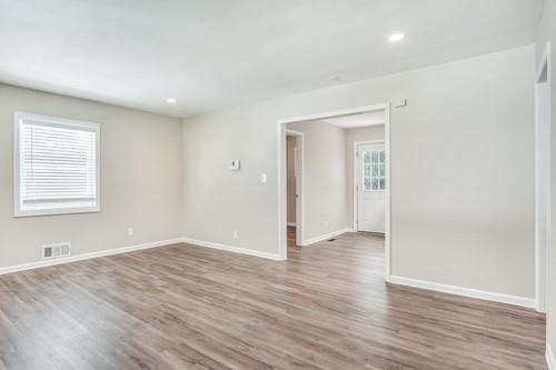3645 Larkspur Terrace Decatur, GA 30032 - Photo 17 of 25 a view of an empty room with wooden floor and a window