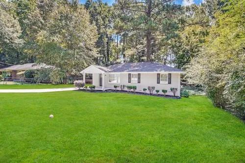 a view of house with garden and deck