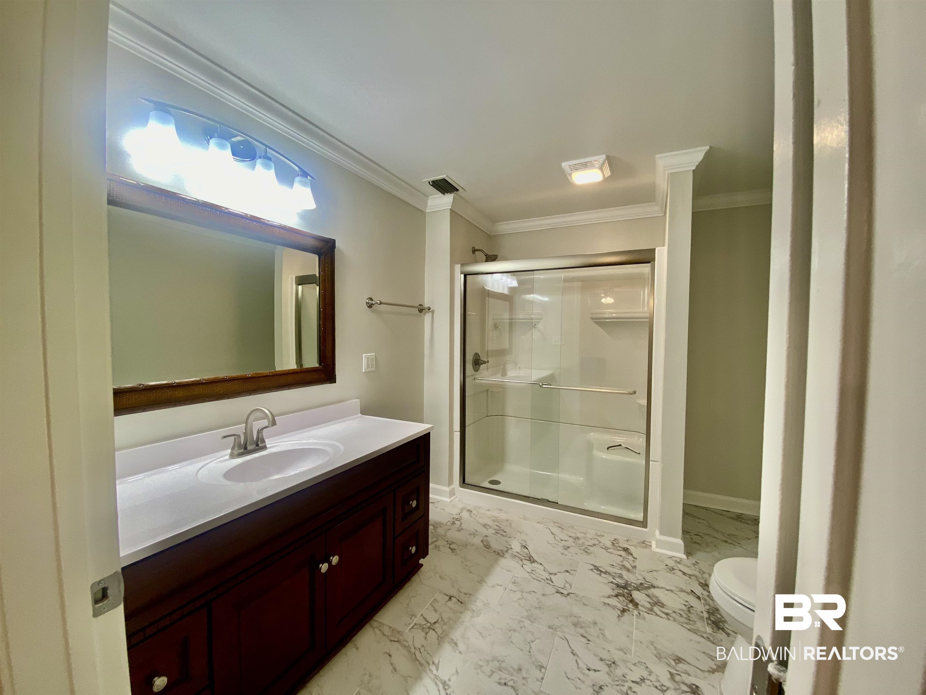 265 Azalea Drive Monroeville, AL 36460 - Photo 27 of 39 Bathroom featuring vanity, toilet, an enclosed shower, and ornamental molding