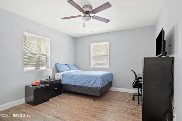 a bedroom with a bed and wooden floor