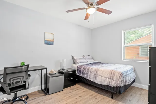 a bedroom with a bed and a window